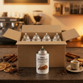 Cargar la imagen en la vista de la galería, Pack aerosol ambientador profesional aroma Canela 250ml Serviaroma Shop, con ramas de canela, anís estrellado y café espresso en barra de cafetería
